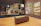Smiling male collector reviewing exclusive art pieces in a private room.