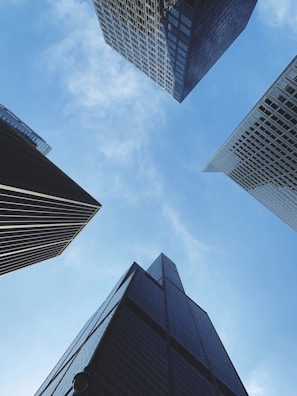 looking up at skyscrapers in a city