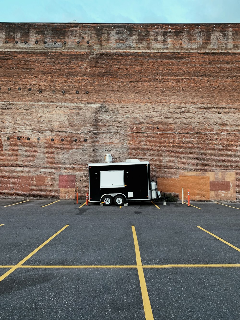 black and white enclosed trailer near wall