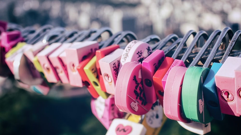a row of colorful padlocks hanging from a line