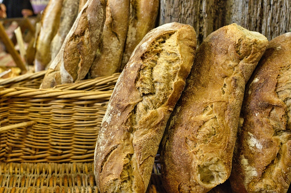 a bunch of loaves of bread in a basket