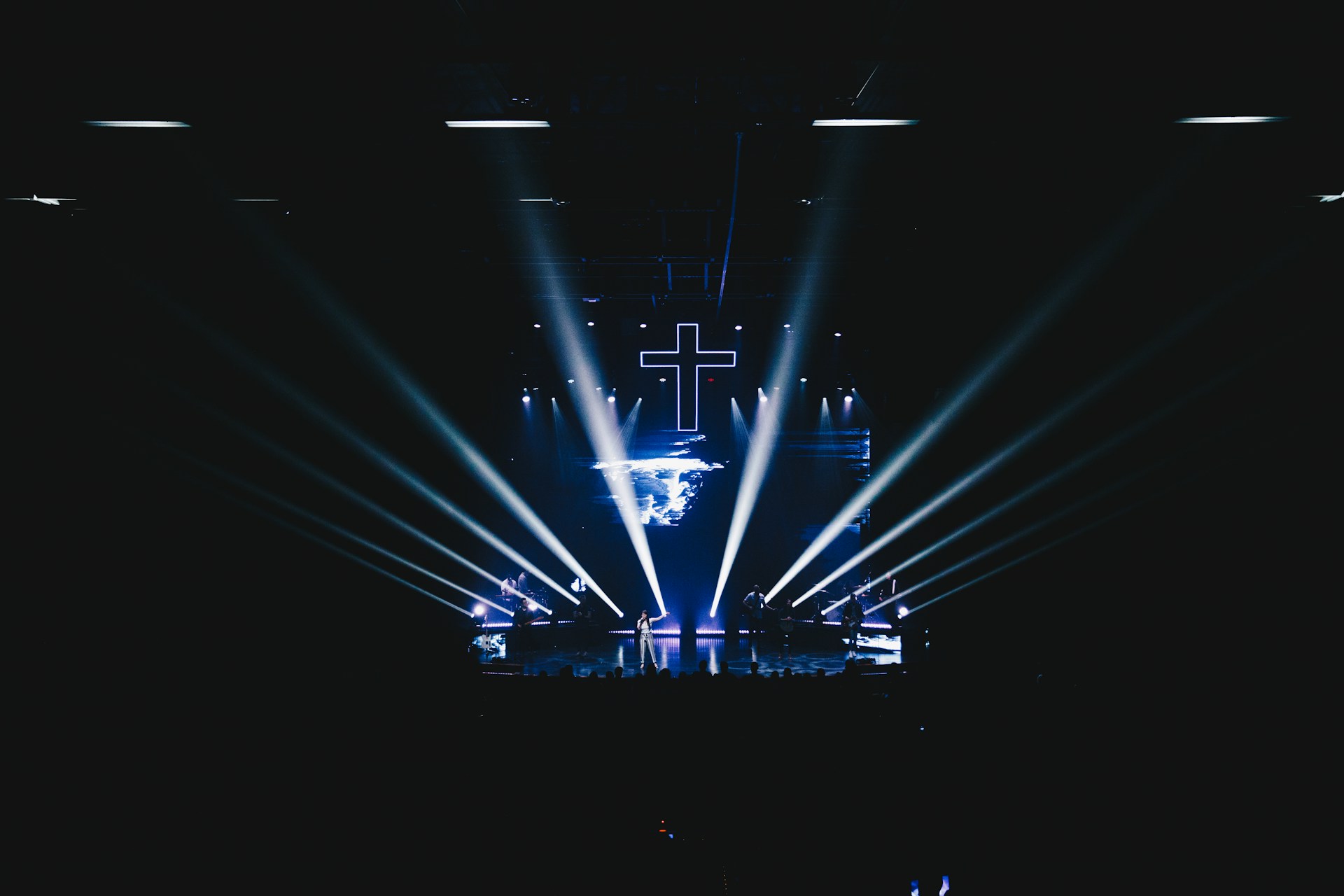 blue stage lights with cross art