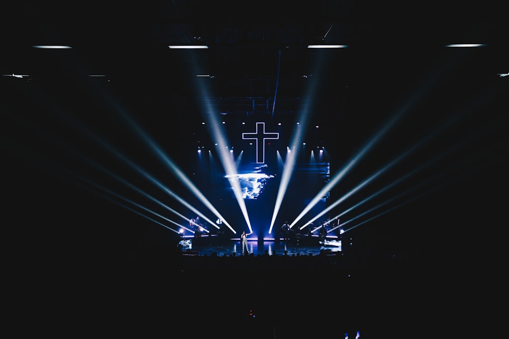 blue stage lights with cross art