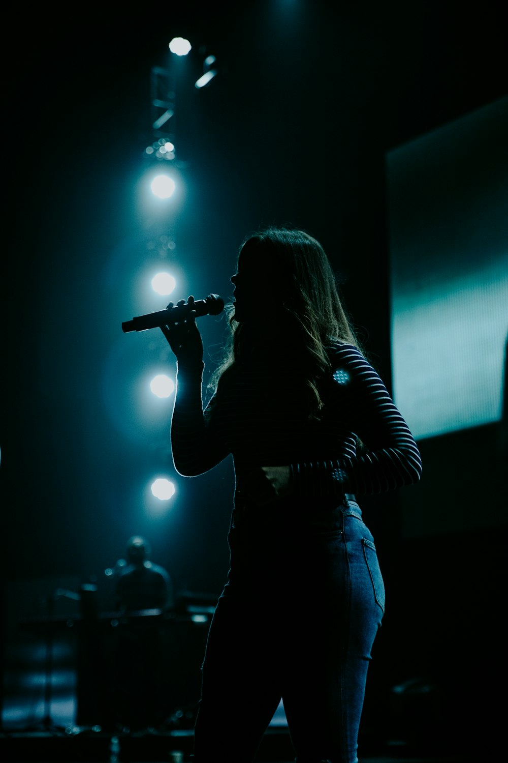 woman holding wireless microphone