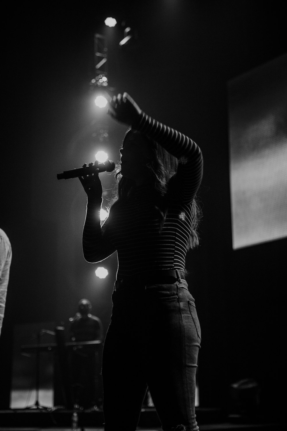 woman singing on stage