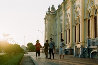A guided tour group standing in front of the Liberty Bell on a sunny day.