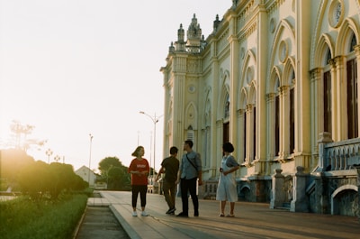 A guided tour group standing in front of the Liberty Bell on a sunny day.