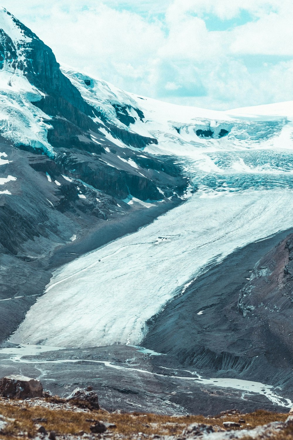 a snow covered mountain with a river running through it