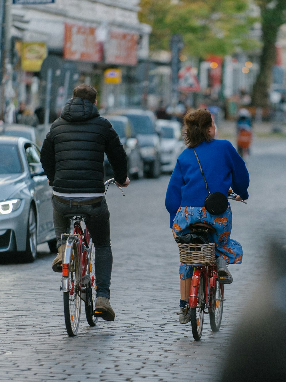 man and woman riding on bicycles