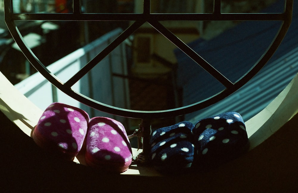 two pairs of pink and black house slippers