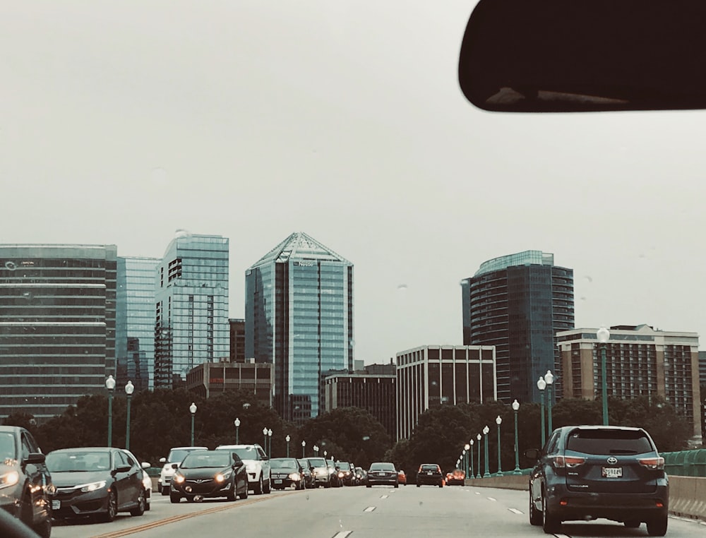 cars on road near high-rise buildings