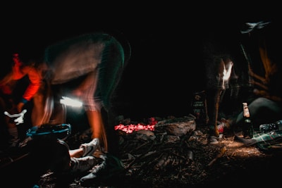 An outdoor scene with Enemy Ender cans beside a campfire at dusk.