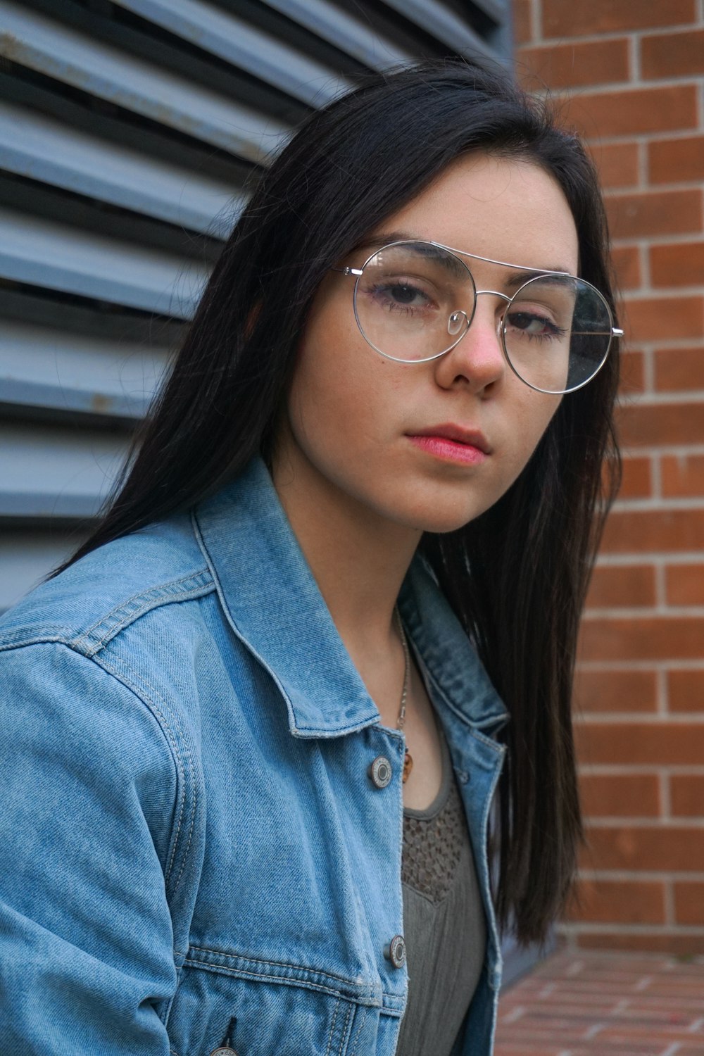 woman wearing blue denim button-up jacket