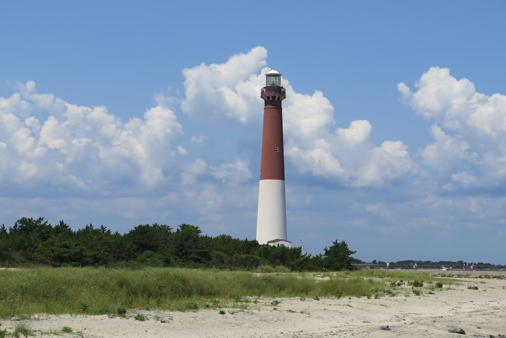 brown and white tower house under blue sky and white clouds