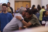 two men hugging on focus photography