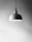 Close-up of a sleek, modern pendant resting on a soft fabric background.