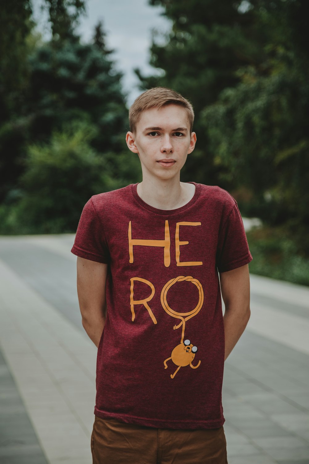 man wearing red hero-printed crew-neck T-shirt