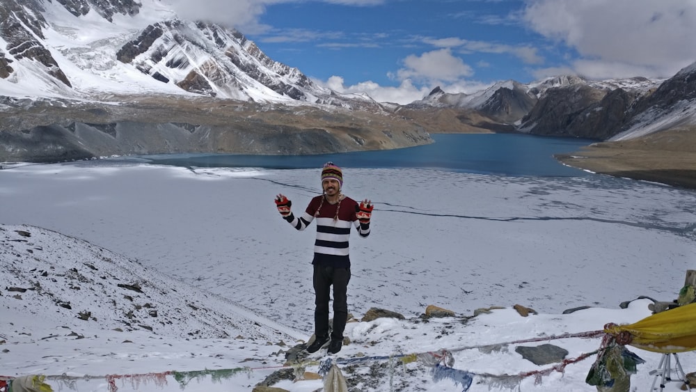 man standing on snow field