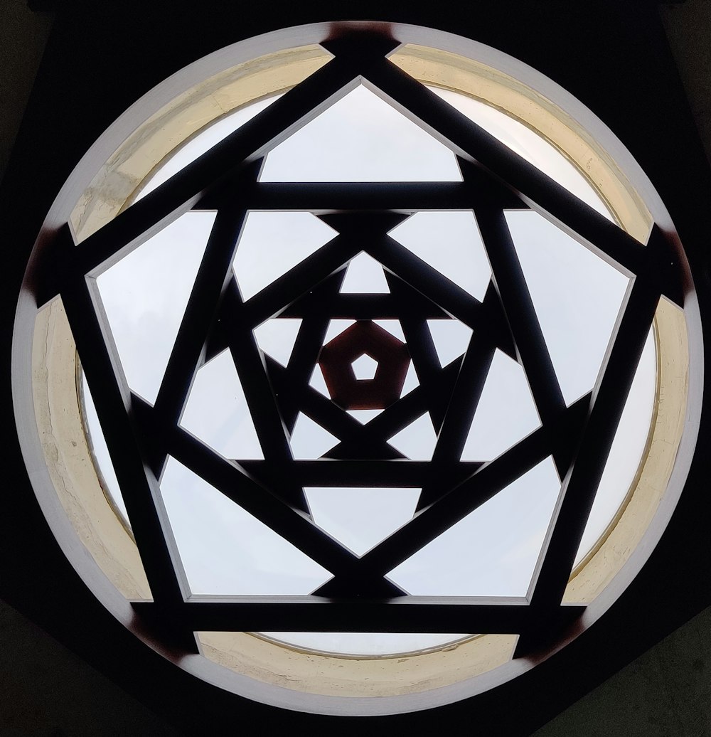 a circular window with a geometric design in the center