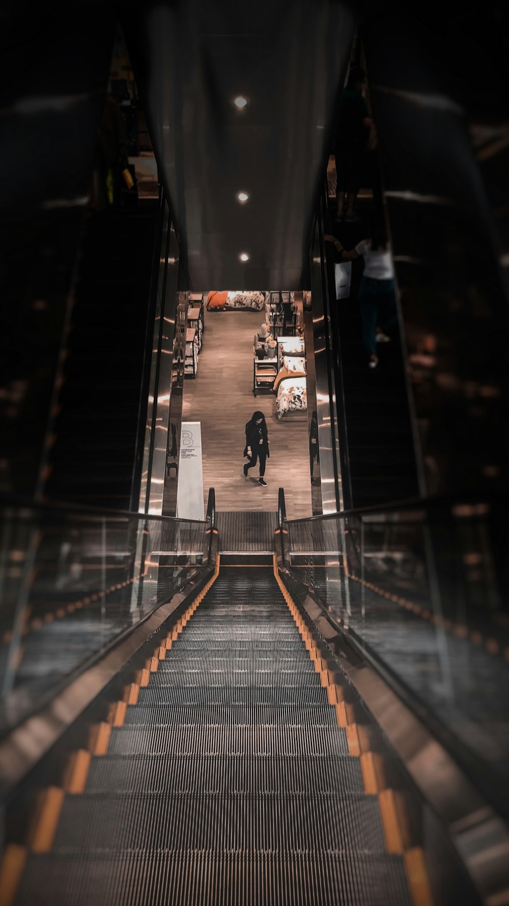 person walking near escalator