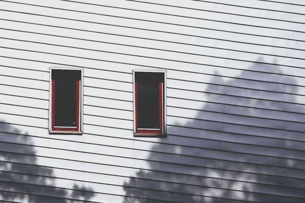 a shadow of two windows on the side of a building