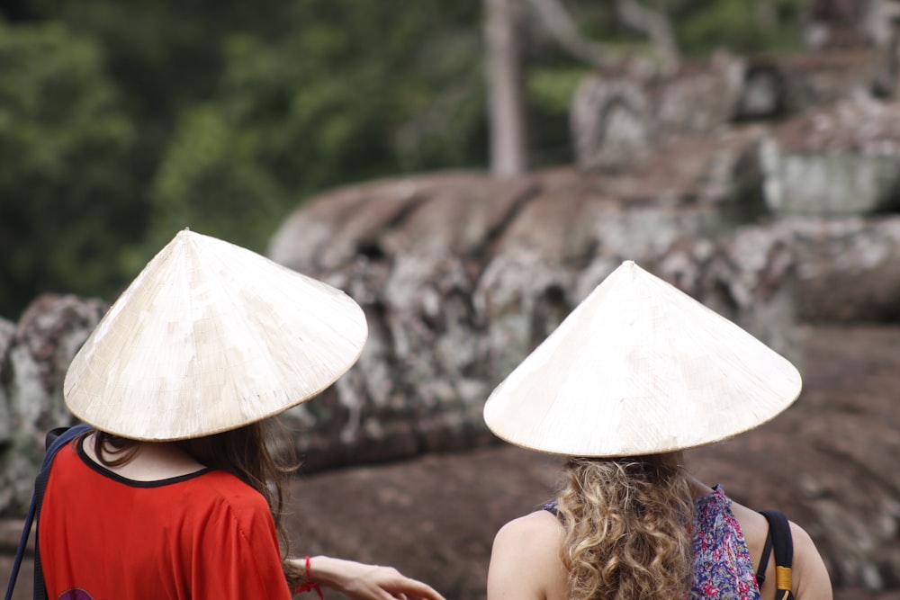 two person wearing brown hat close-up photography