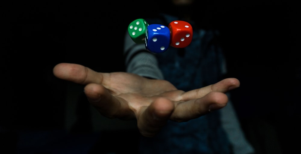 person throwing three dices