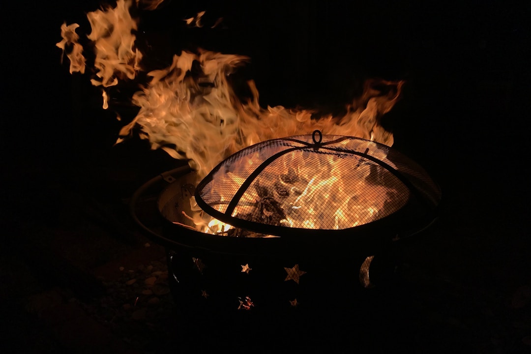 Modern backyard fire pit at twilight creating a cozy outdoor living atmosphere
