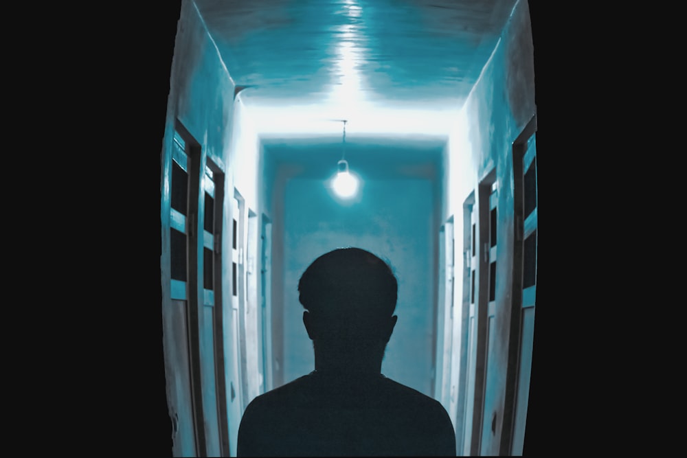 silhouette of man standing on hallway