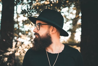 man standing under tree looking sideward