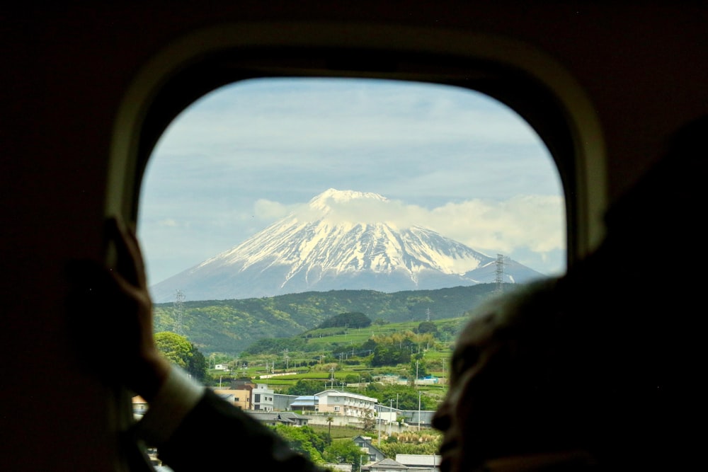 airplane window view of buildings and glacier mountain