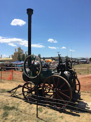 An outdoor agricultural exhibition showcasing modern farming equipment.
