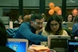 A group of diverse people engaged in a technology workshop.