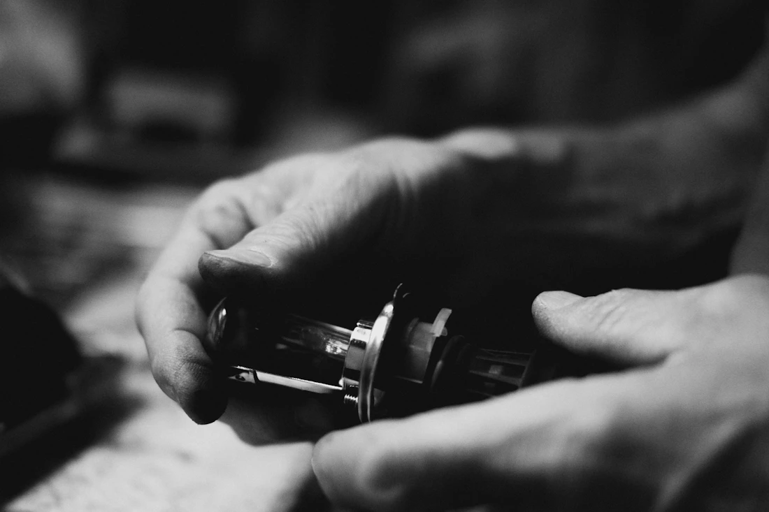 Hands carefully finishing a small precision part