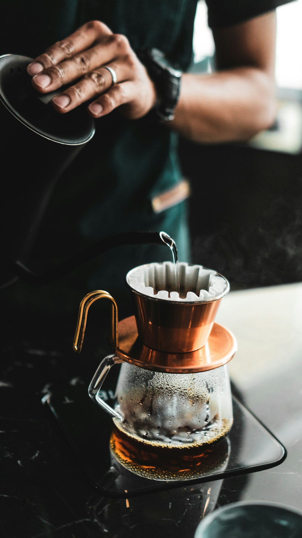 person pouring tea in cup