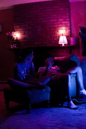 A cozy setting with two people sharing a warm, intimate moment on a couch.