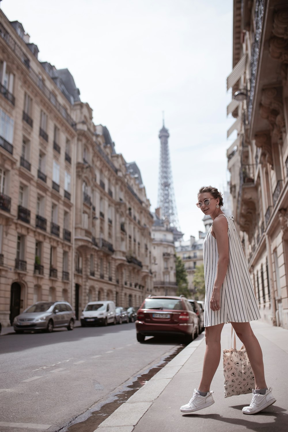 woman standing on sidewalk