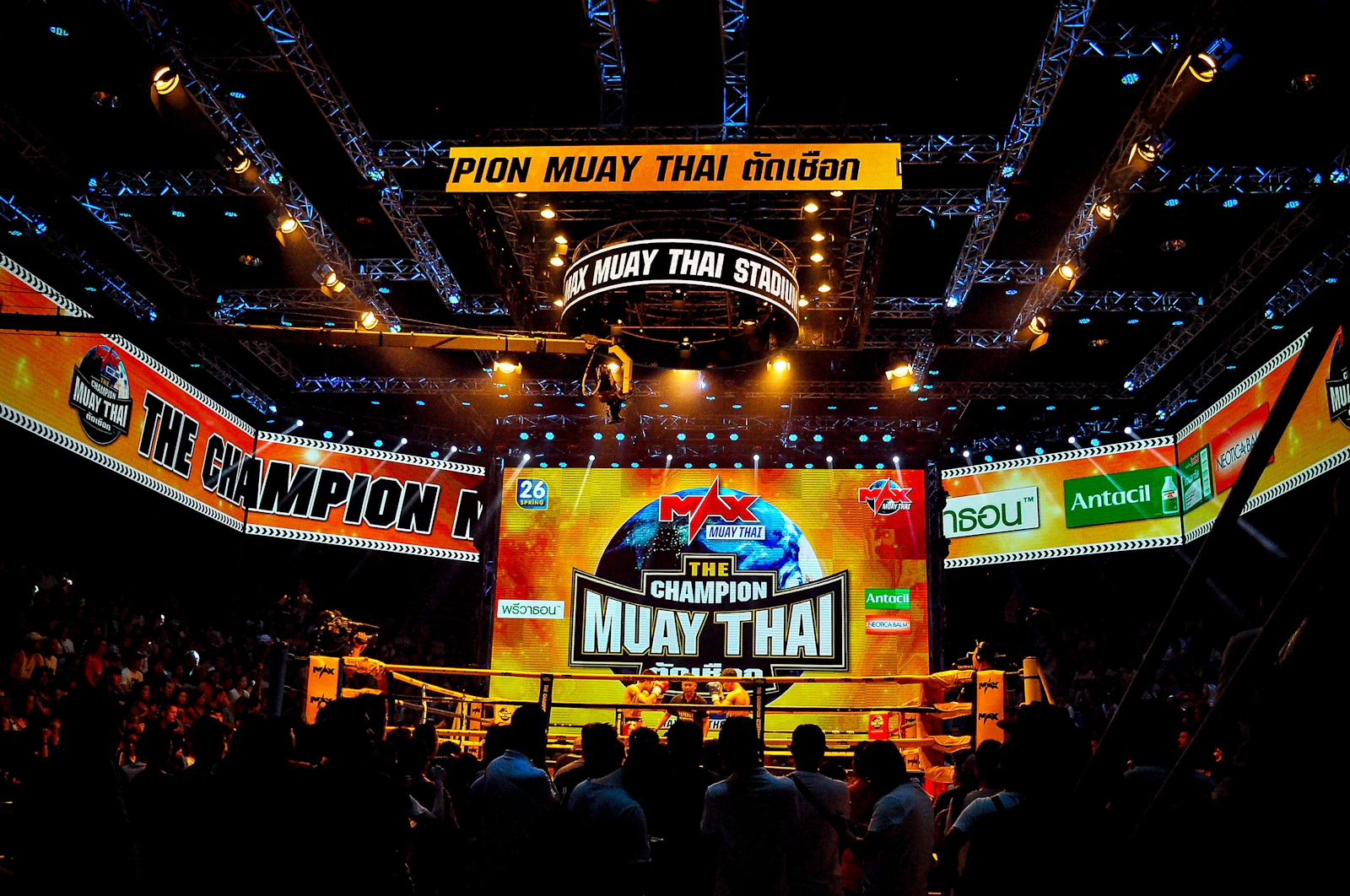 A packed Muay Thai stadium event under bright lights