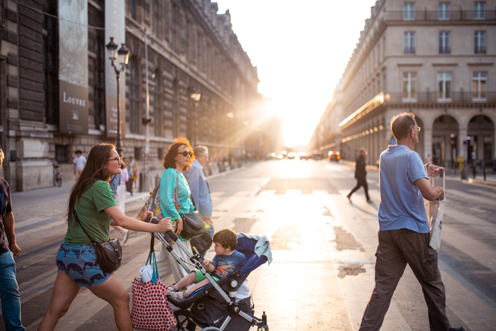 woman pushing stroller at middle of pedestrian lane