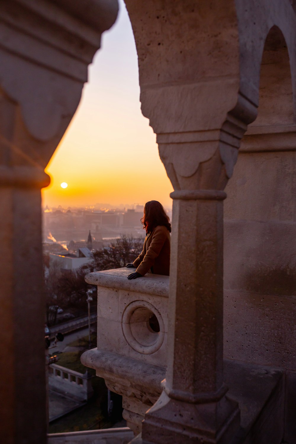 woman at the balcony of a building during day