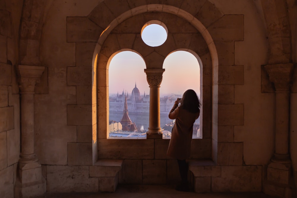 woman standing on window