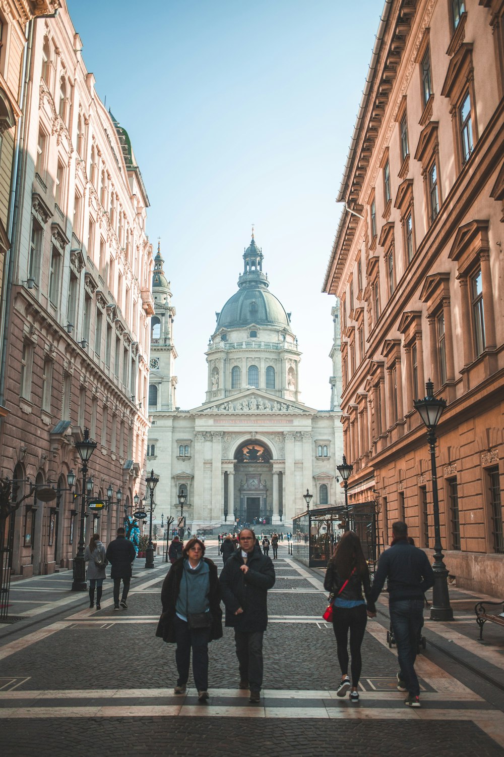 people walking beside buildings during daytime