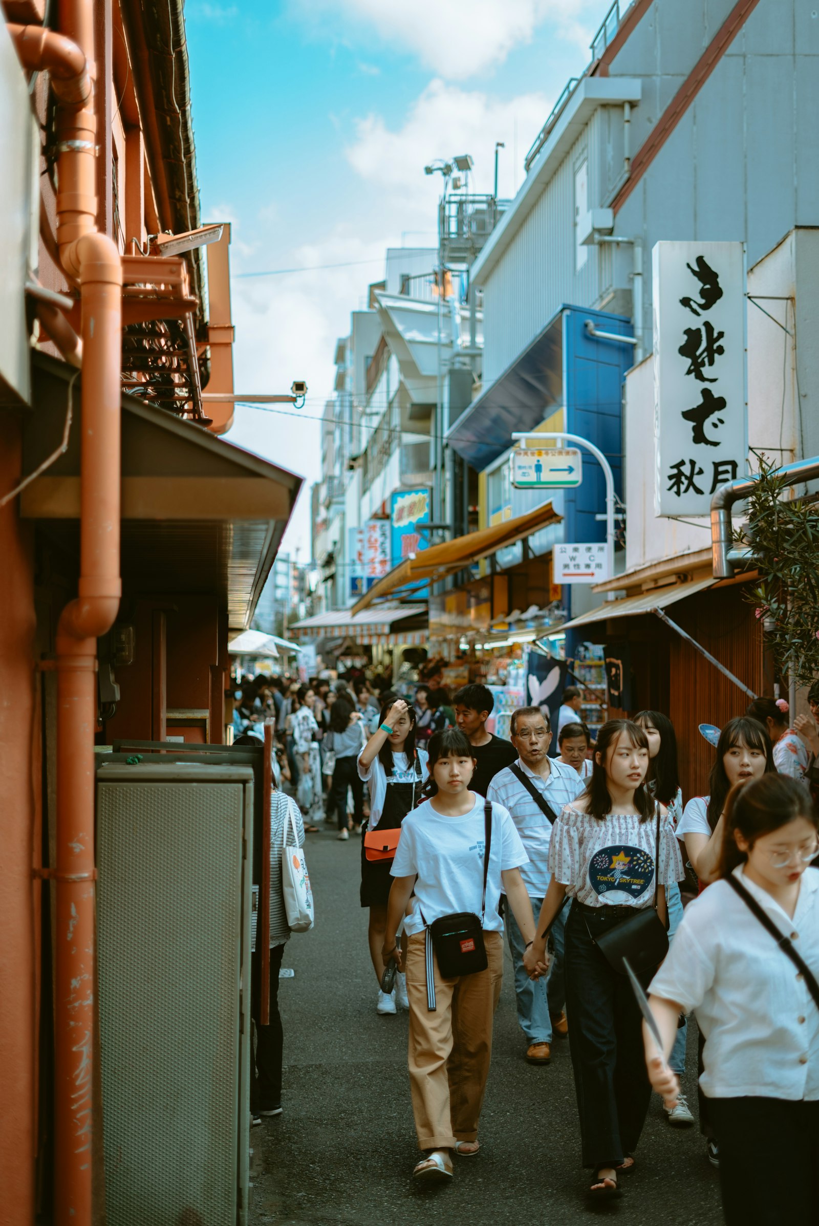 Sony a7S II + Sony FE 50mm F1.8 sample photo. People walking near buildings photography