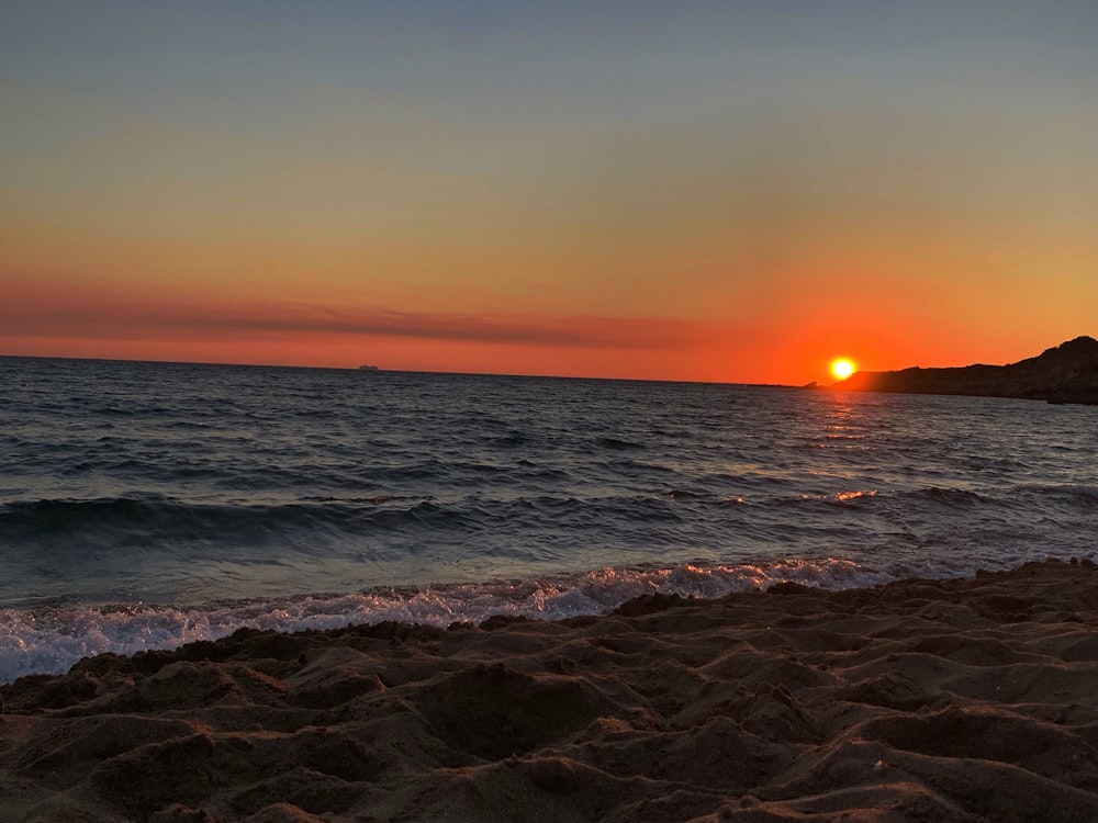 blue sea during sunrise