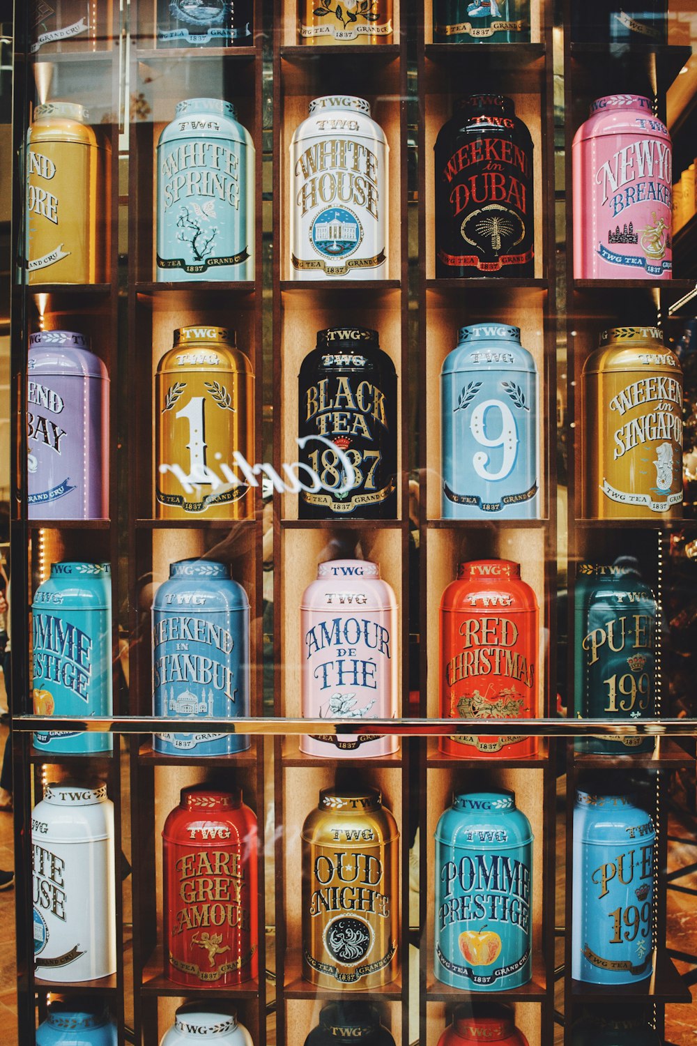 assorted decorative cans on rack