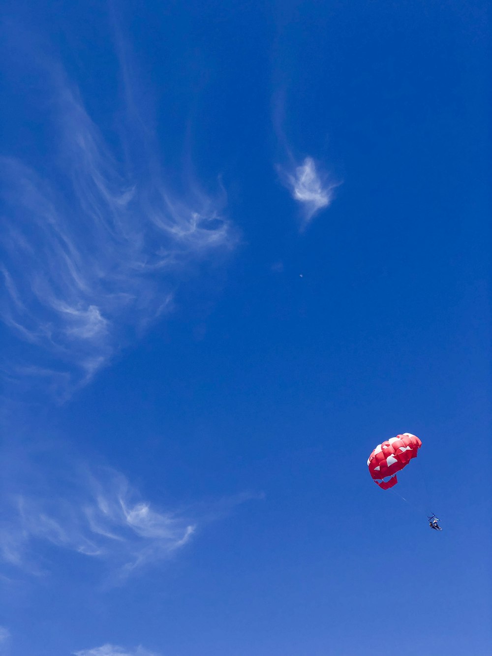 person with white and red parachute
