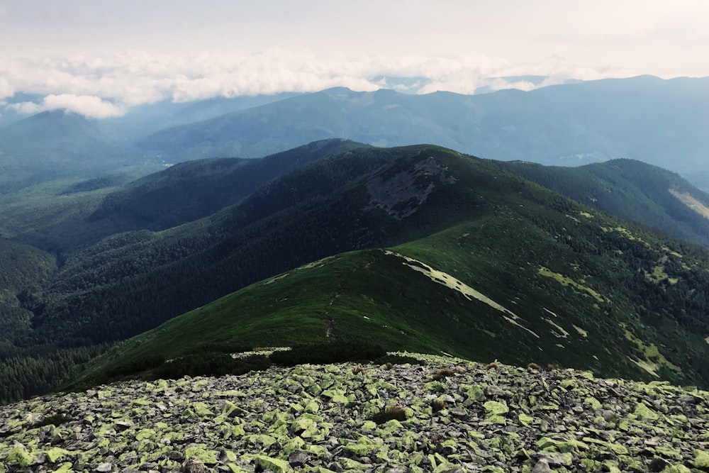 green mountain view under white skies