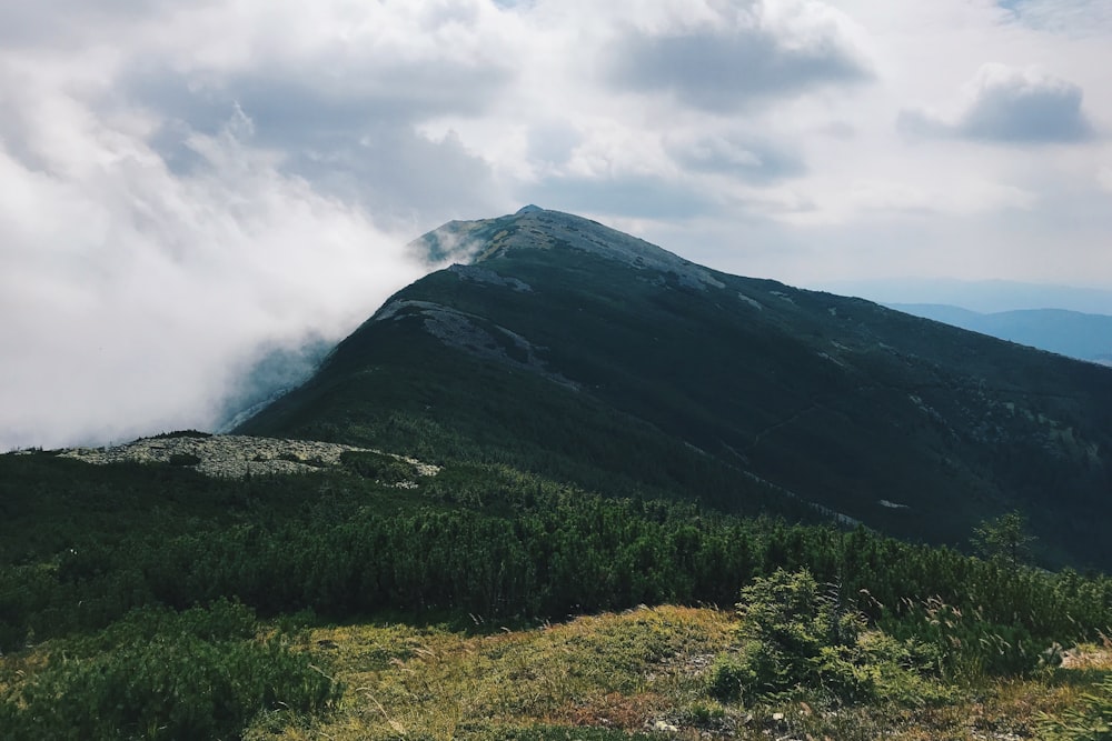 green mountain under white sky at daytime