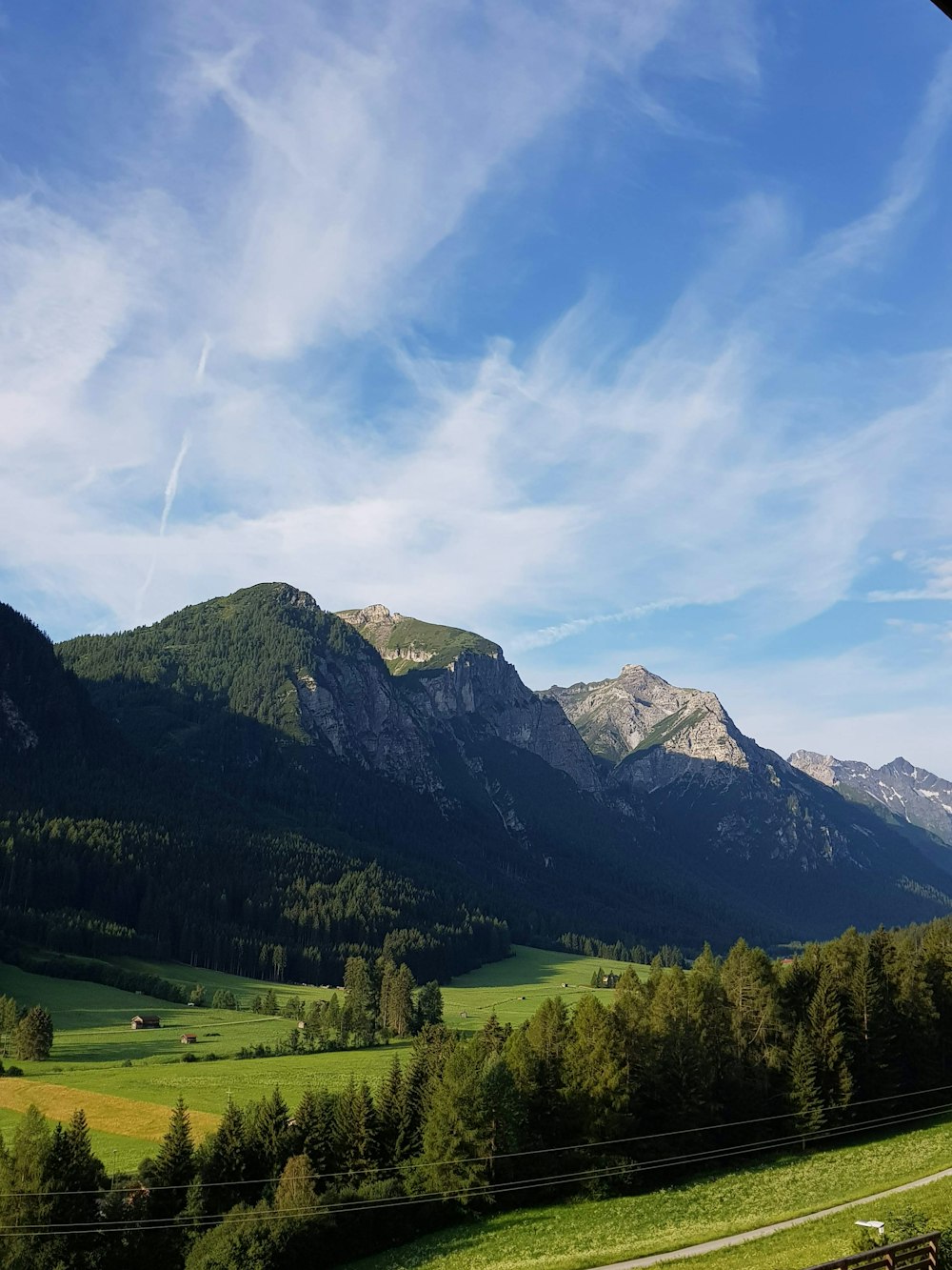 grey mountain under white clouds