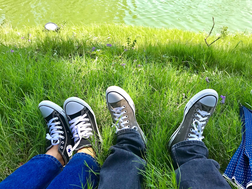 two person lying on grass fields